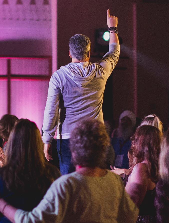 Attendee reaching upward